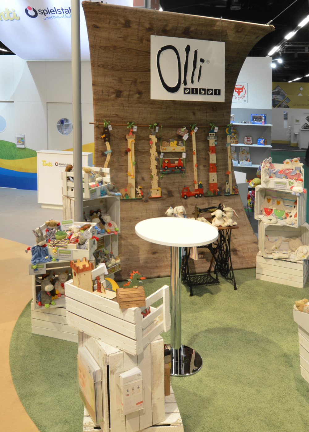 The Olli Olbot brand’s product range at the joint booth of Tinti, Spielstabil, and Olli Olbot at the Nuremberg Toy Fair. Natural materials, a wood-like appearance, and lovingly presented wooden toys create a warm brand experience that is inviting and offers a clear product focus.