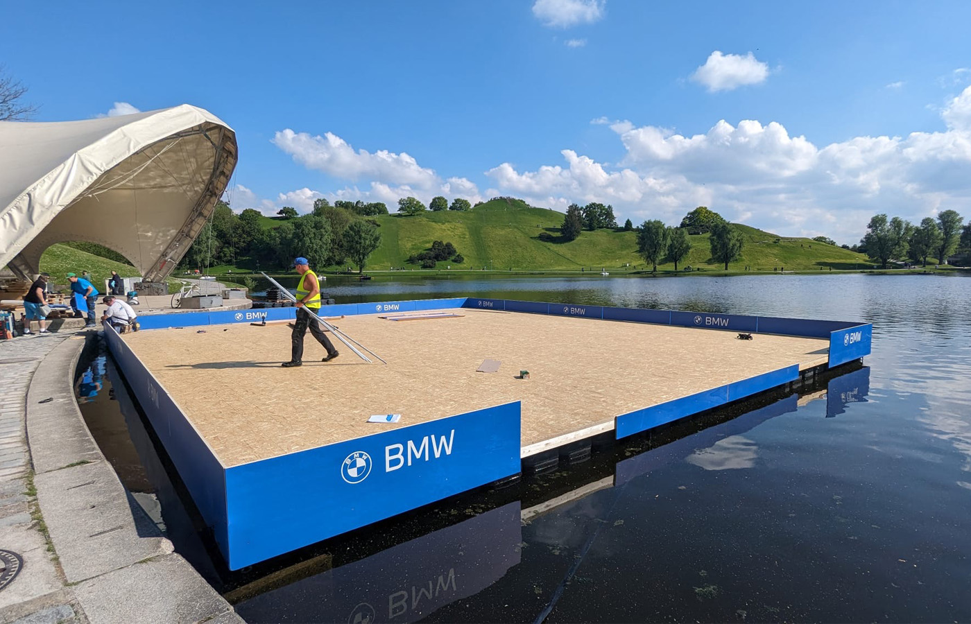 Construction of the floating event platform for FC Bayern Basketball and BMW at Munich's Olympic Park.